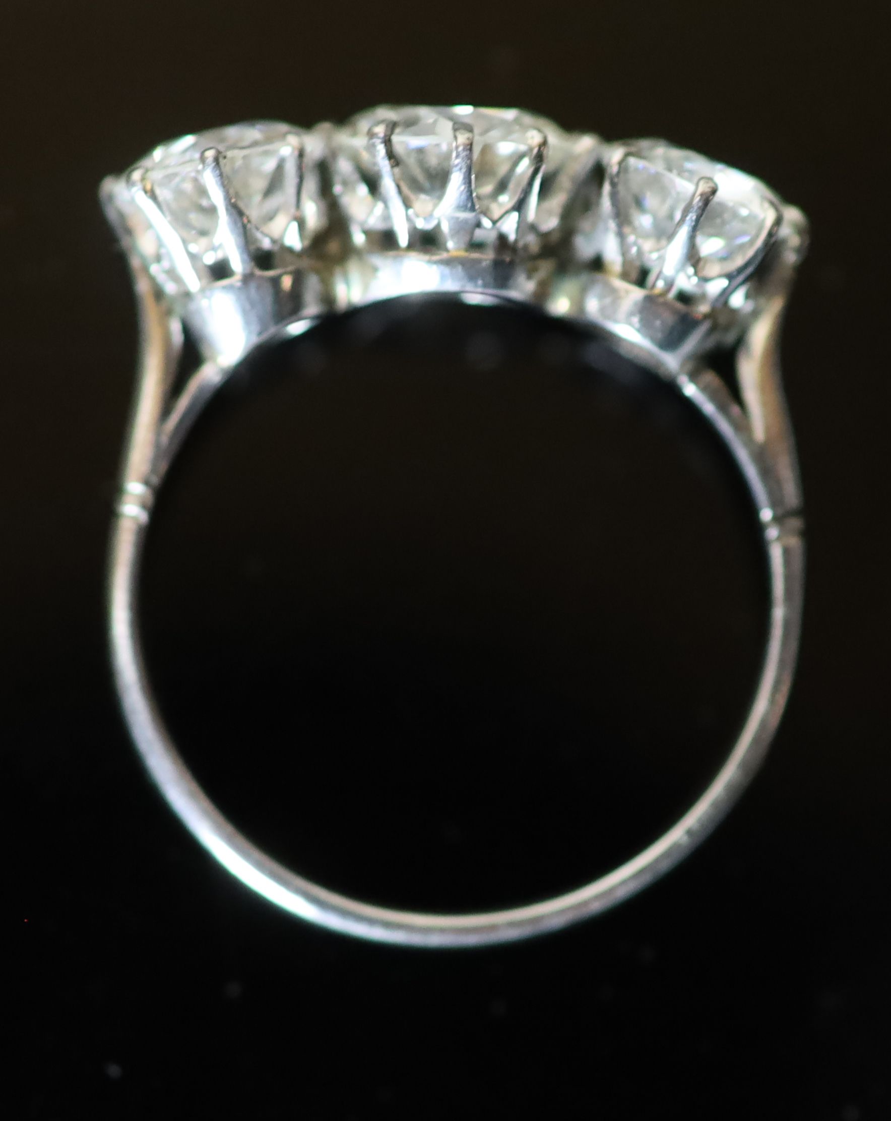 A platinum and three stone diamond ring,